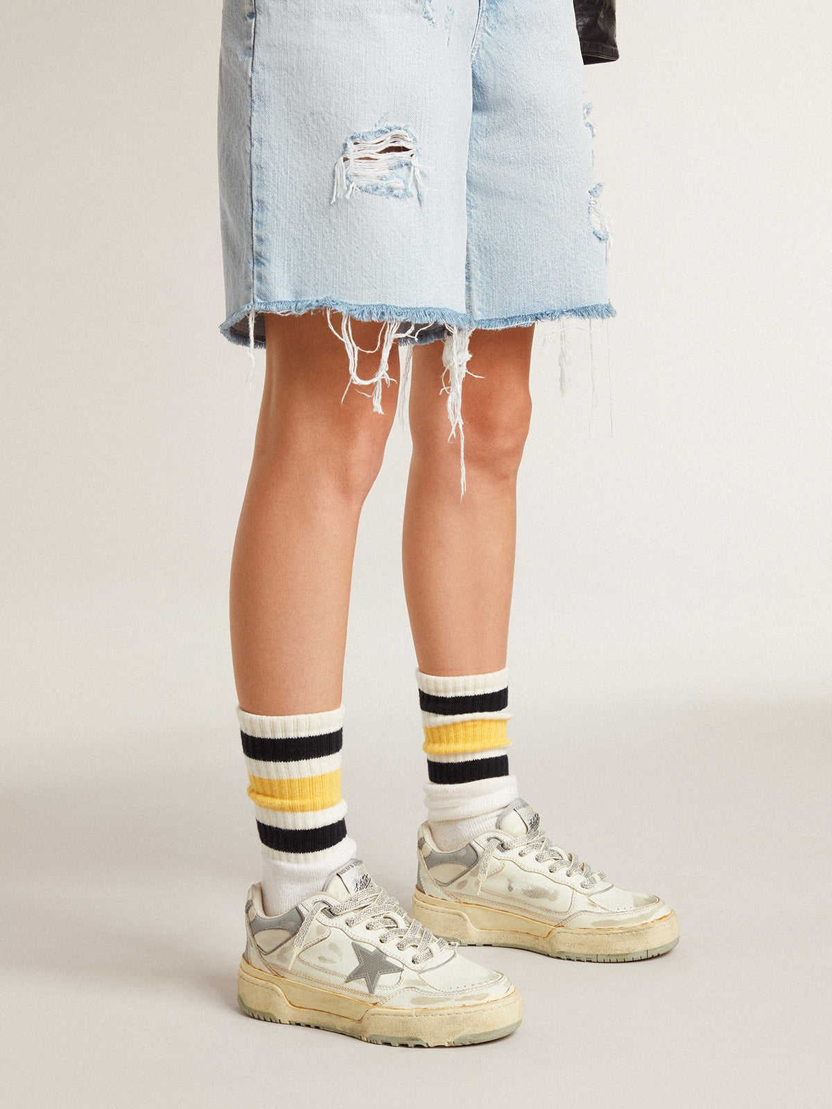 Golden Goose Worn-white socks with distressed details and black and yellow stripes
