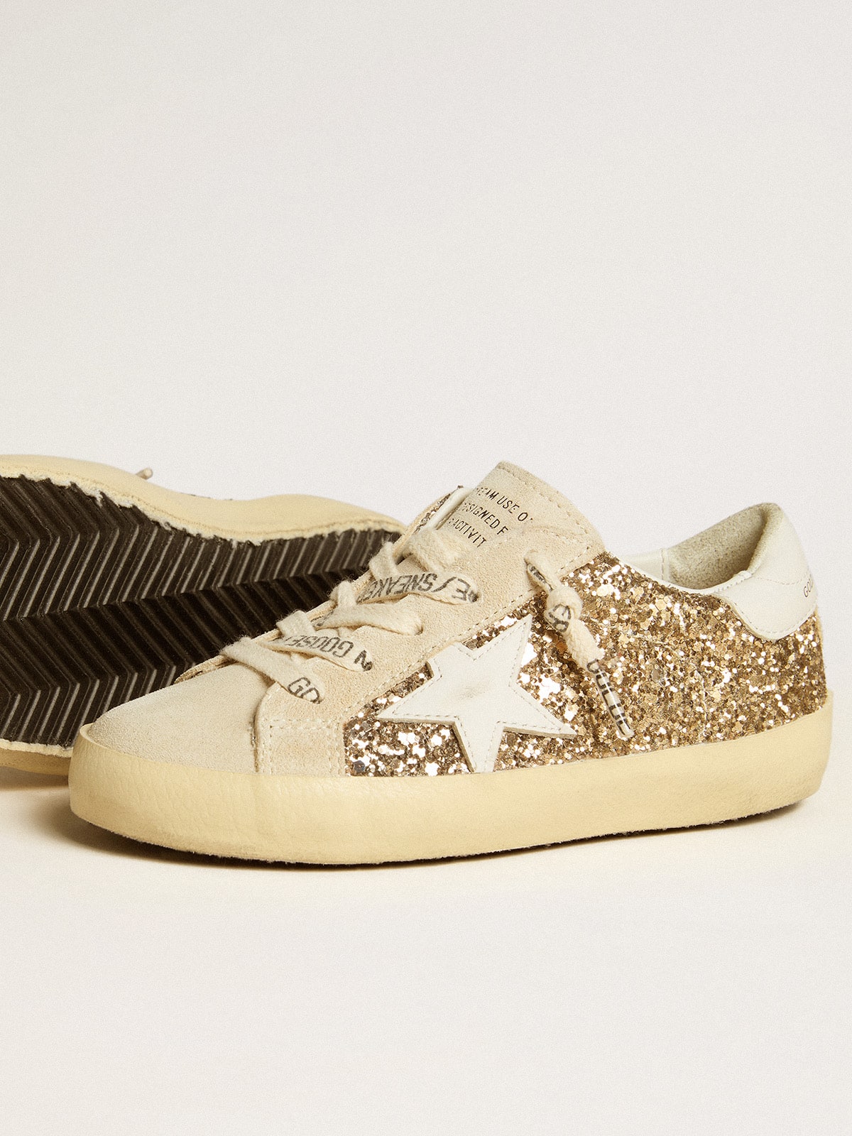 Golden Goose Super-Star Young in gold glitter with white leather star and heel tab